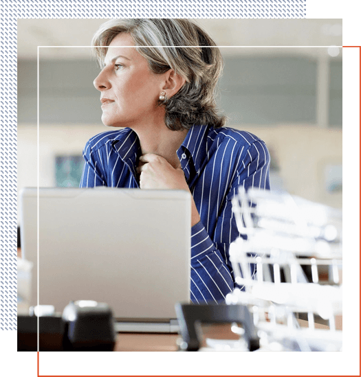 A woman sitting at her desk with a laptop.