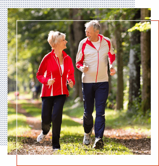 A man and woman walking in the woods