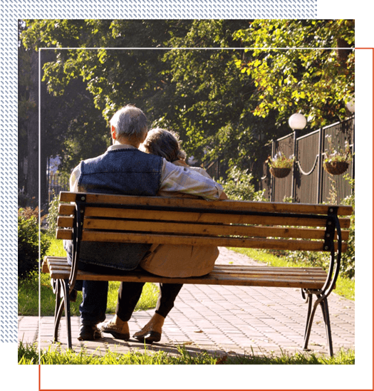 A couple sitting on top of a wooden bench.